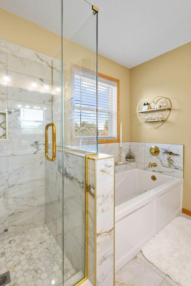 bathroom featuring shower with separate bathtub and a textured ceiling