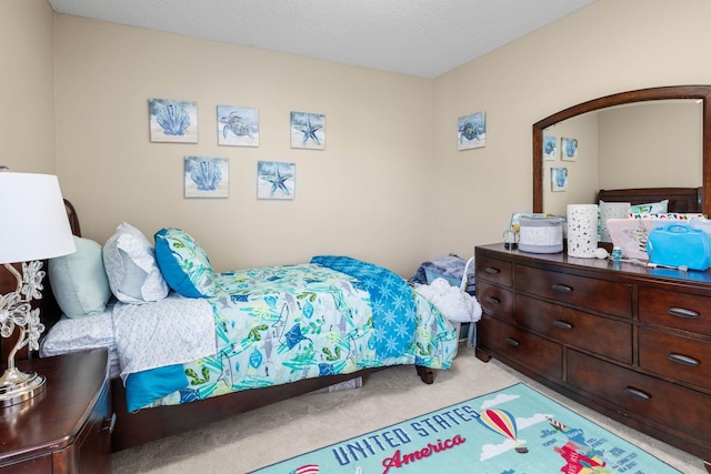 carpeted bedroom with a textured ceiling