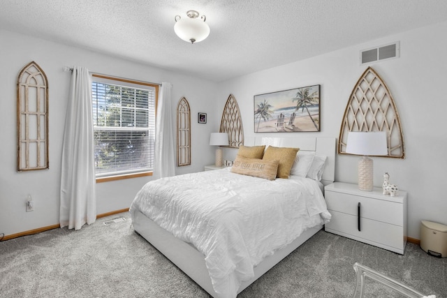 carpeted bedroom featuring a textured ceiling