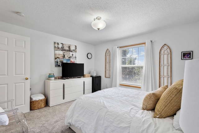 carpeted bedroom featuring a textured ceiling