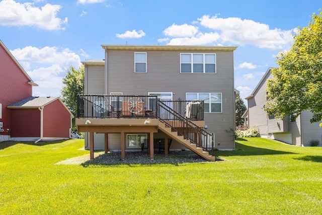 rear view of property with a yard and a wooden deck