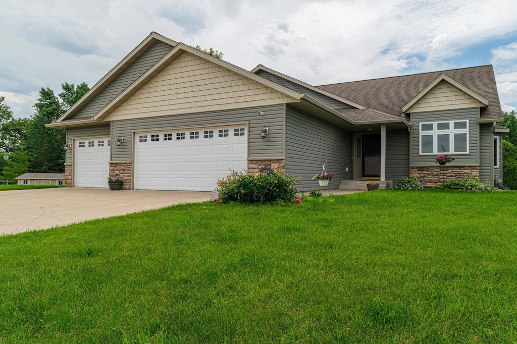 view of front of house with a front lawn and a garage