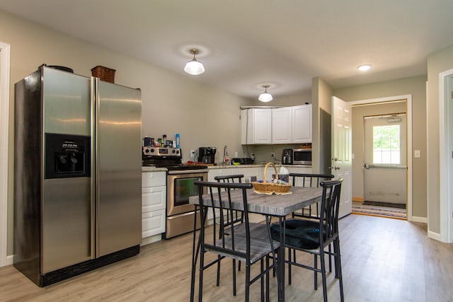 kitchen featuring white cabinetry, stainless steel appliances, and light hardwood / wood-style flooring