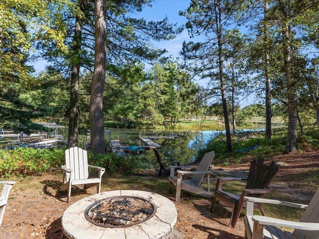 view of patio with a water view and an outdoor fire pit