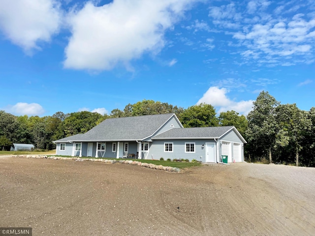 ranch-style home with dirt driveway