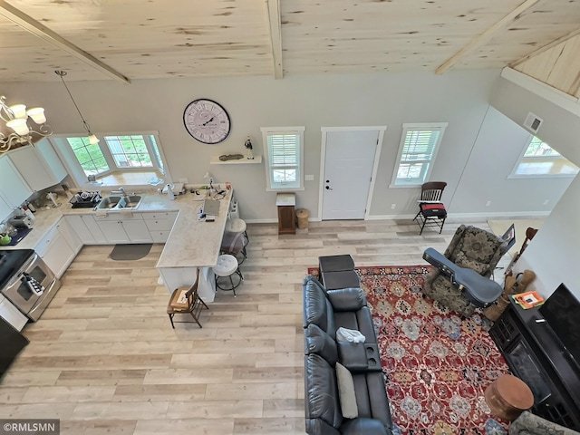 living room with wooden ceiling, light wood-style flooring, baseboards, and beamed ceiling