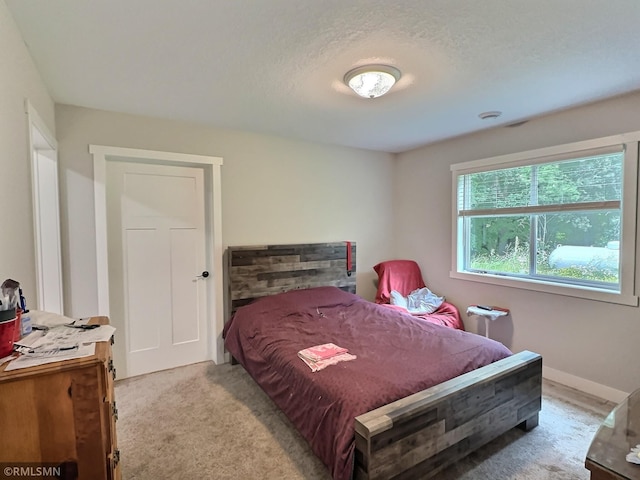 bedroom with light carpet and baseboards