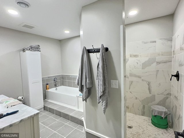 bathroom featuring recessed lighting, a walk in shower, visible vents, and a bath