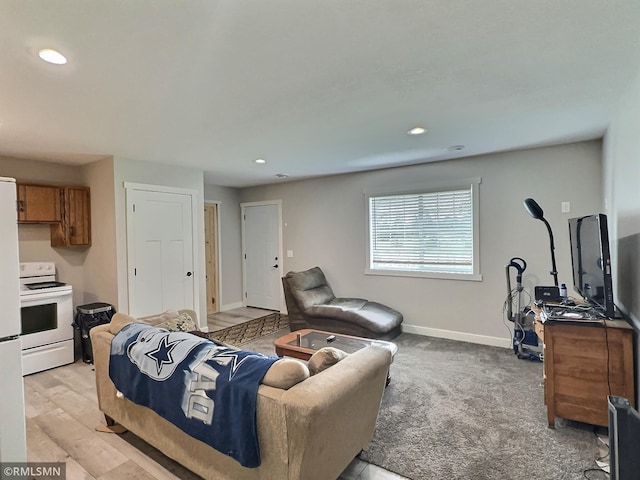 living area with recessed lighting and baseboards