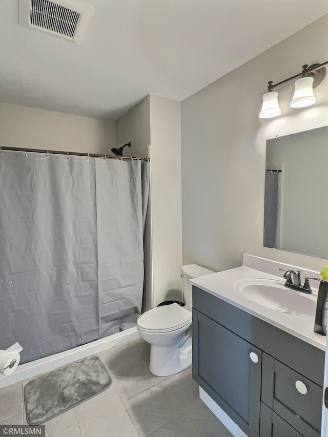 bathroom featuring visible vents, toilet, a stall shower, vanity, and tile patterned floors