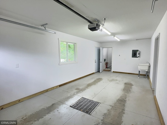 garage with visible vents, electric panel, baseboards, and a garage door opener