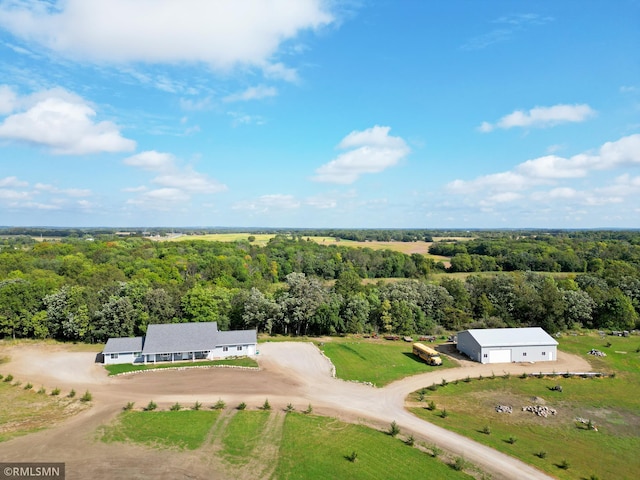 birds eye view of property featuring a view of trees