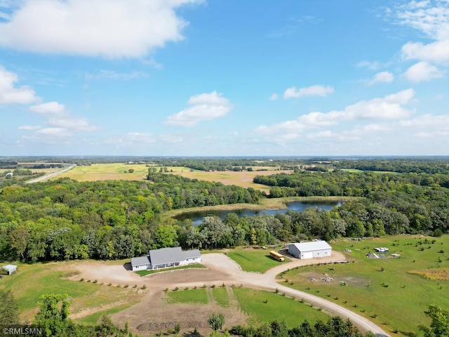 drone / aerial view featuring a water view, a view of trees, and a rural view