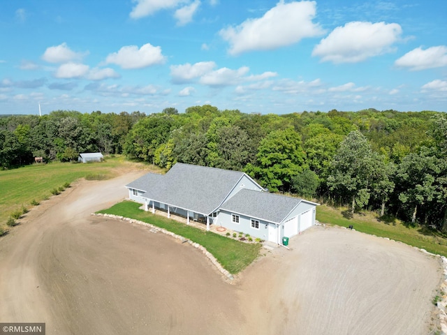 drone / aerial view with a wooded view