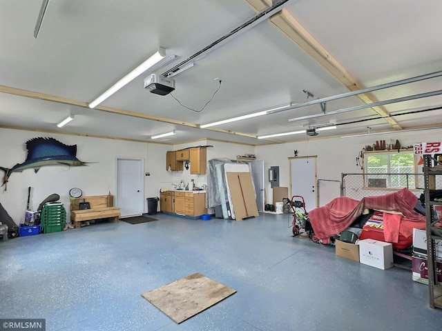 garage with electric panel and a garage door opener