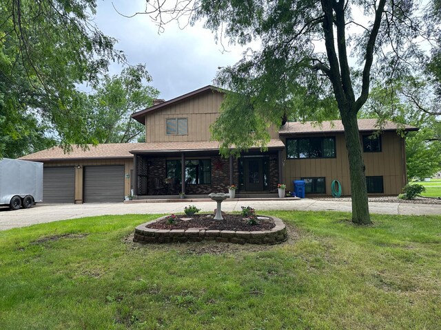 view of front facade with a garage and a front lawn