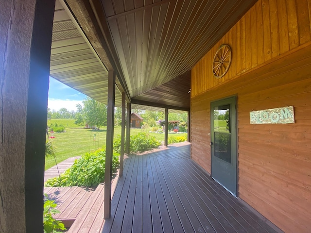 wooden deck with a lawn