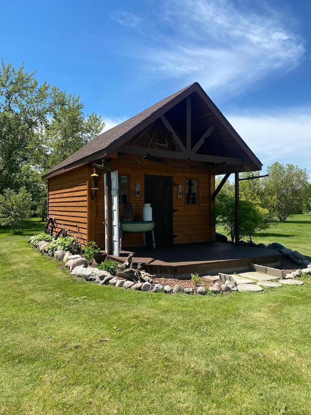 rear view of property featuring a yard