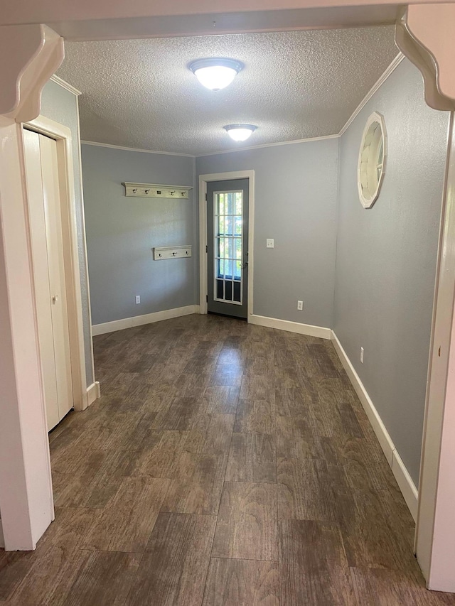 entryway featuring wood finished floors, a textured ceiling, and crown molding
