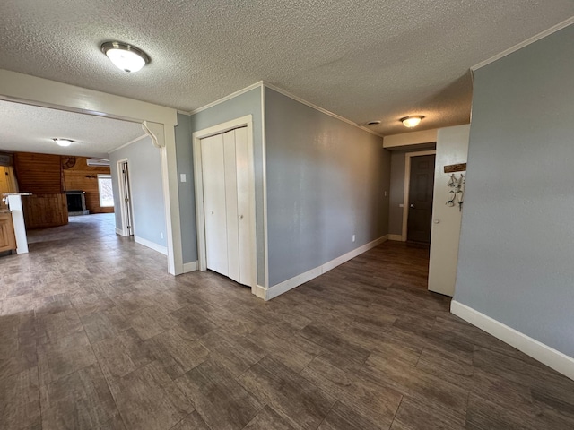 empty room with a textured ceiling and ornamental molding