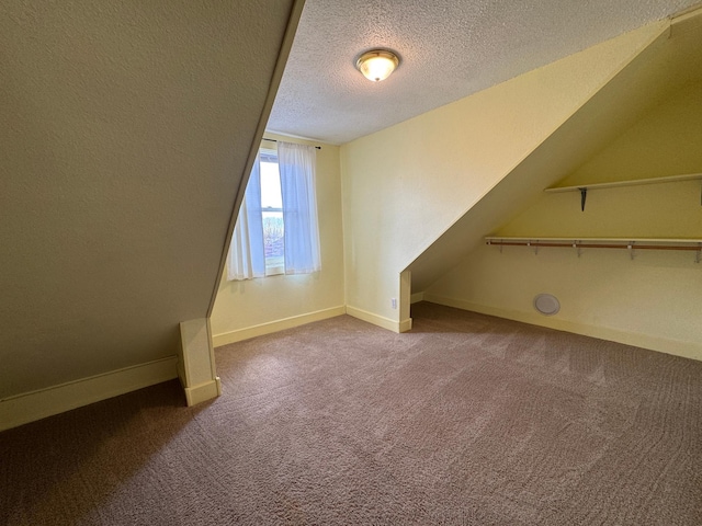 bonus room with baseboards, a textured ceiling, and carpet floors