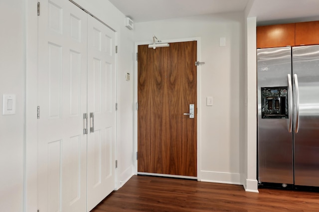 kitchen featuring dark wood-type flooring and stainless steel fridge