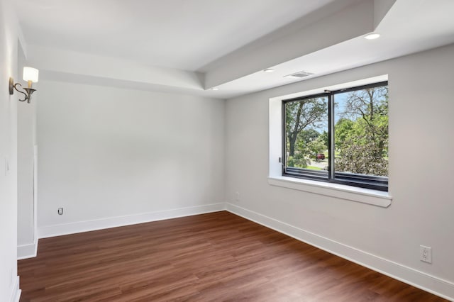 spare room with dark wood-type flooring