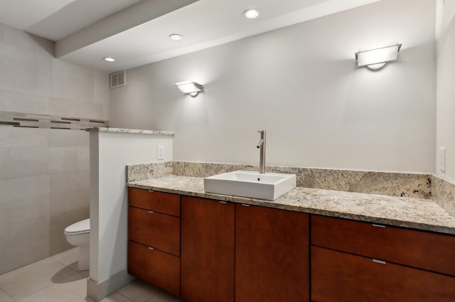 bathroom featuring tile patterned flooring, vanity, and toilet