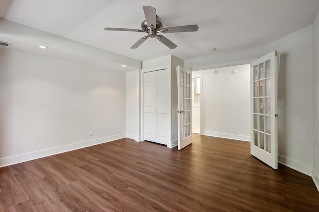 unfurnished room with ceiling fan and dark hardwood / wood-style flooring