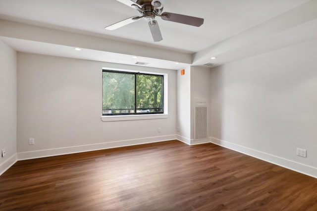 unfurnished room with ceiling fan and dark hardwood / wood-style flooring