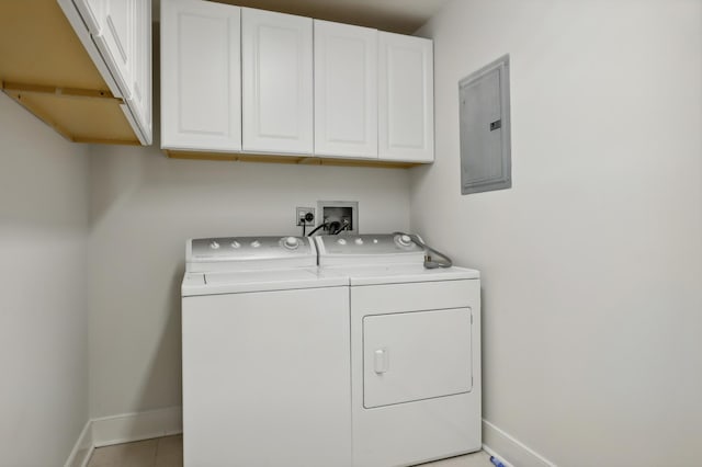 laundry area featuring cabinets, washing machine and dryer, light tile patterned floors, and electric panel