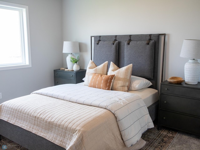 bedroom featuring dark carpet