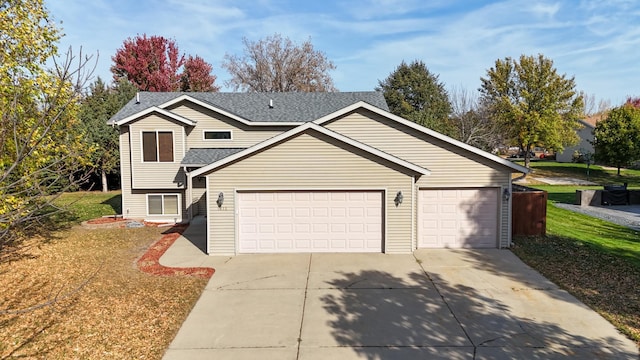 view of front of house with a front yard and a garage