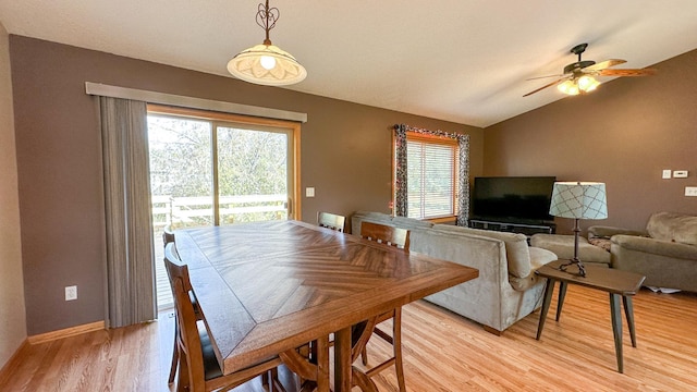 dining space featuring vaulted ceiling, ceiling fan, light wood-type flooring, and plenty of natural light