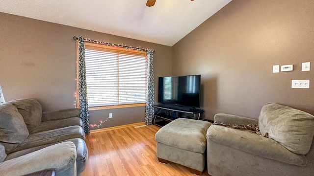 living room featuring vaulted ceiling, light wood-type flooring, and ceiling fan