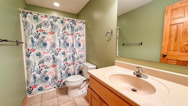 bathroom with walk in shower, vanity, toilet, and tile patterned floors