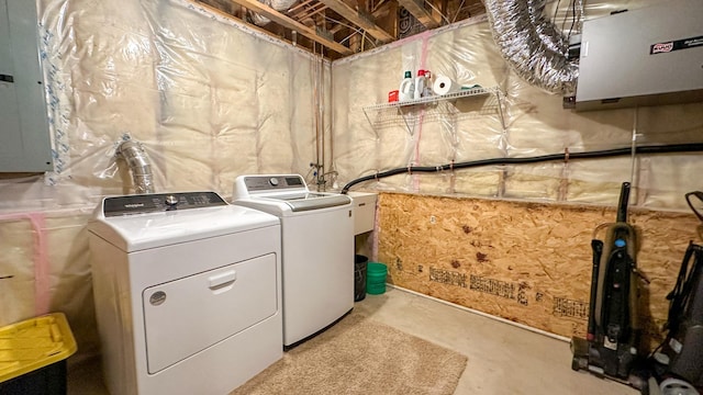 laundry area with electric panel and washer and dryer