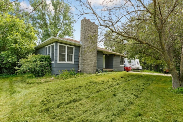 exterior space featuring a lawn and a chimney