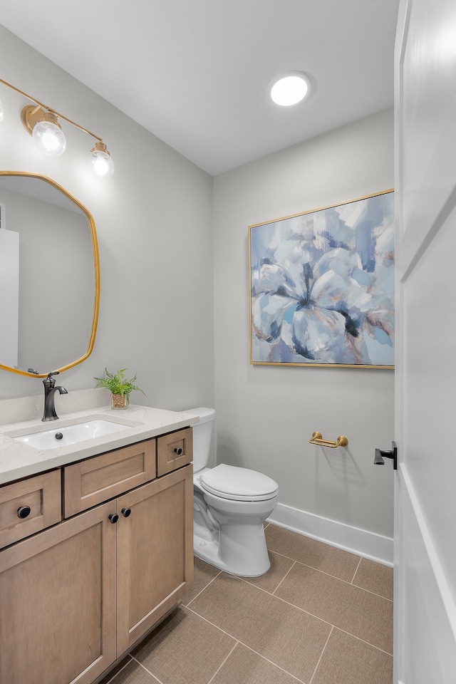 bathroom featuring vanity, tile patterned flooring, and toilet