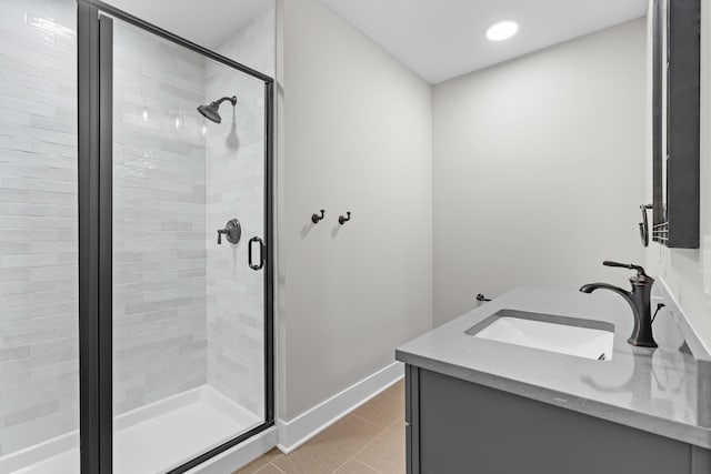 bathroom featuring tile patterned floors, an enclosed shower, and vanity