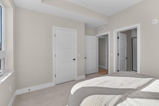 bedroom featuring light colored carpet