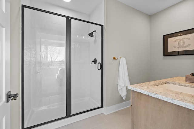 bathroom featuring tile patterned flooring, vanity, and an enclosed shower