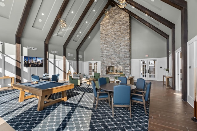 playroom featuring dark hardwood / wood-style floors, a fireplace, beamed ceiling, pool table, and french doors