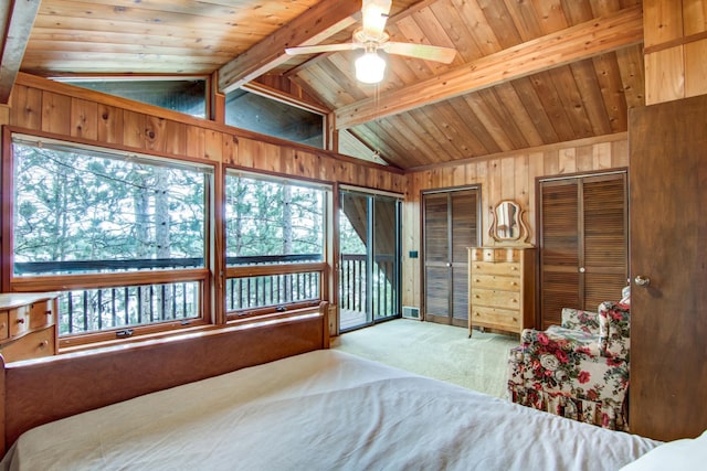 bedroom featuring carpet floors, multiple windows, lofted ceiling with beams, and wood walls