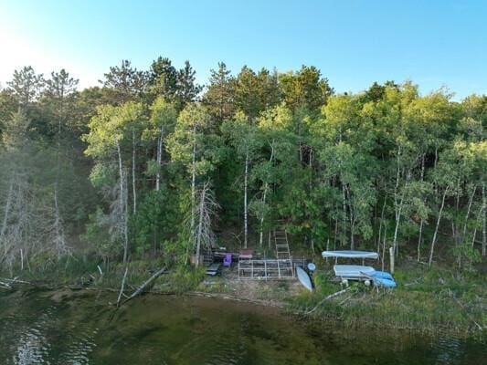 exterior space featuring a wooded view