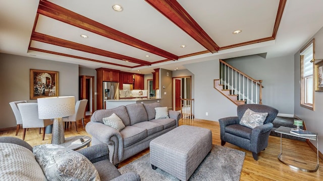 living room with light wood-type flooring and beamed ceiling