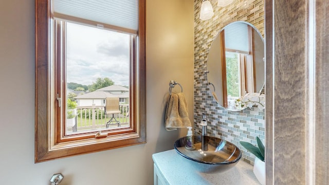 bathroom featuring sink and backsplash