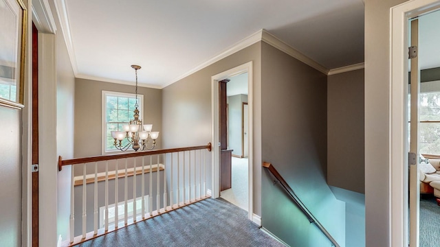 hallway with ornamental molding, carpet, and a notable chandelier