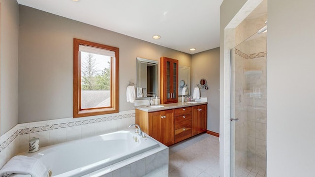 bathroom featuring vanity and independent shower and bath