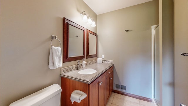 bathroom featuring toilet, vanity, and tile patterned floors